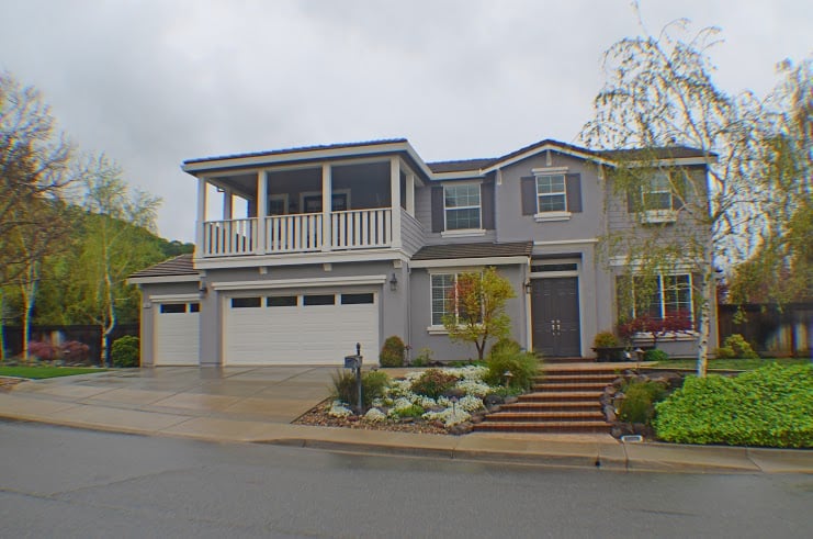 Gray two-story home with balcony
